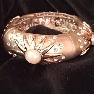 Goldtone metal bracelet with inset faux-pearls and rhinestines